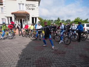 a group of people on bikes in front of a building at Hotel Margo in Cedynia