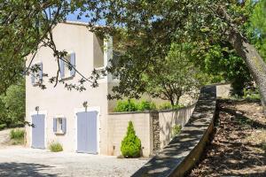 a house with two white doors and a fence at Ménerbes Home with Private Pool in Ménerbes