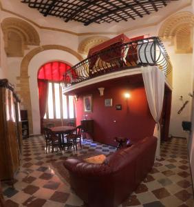 a living room with a couch and a bunk bed at Antica Corte delle Ninfee, Historical Private Villa in Trapani