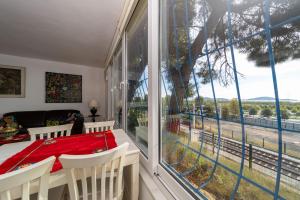 a dining room with a table and a large window at House with Tree Inside near Sea in Maltepe in Istanbul