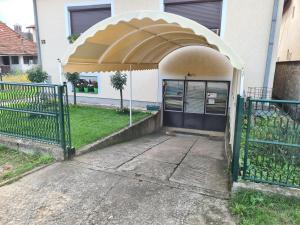 an entrance to a building with an open gate at Apartman Bubamara in Arilje