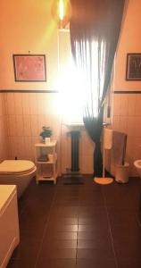a bathroom with a white toilet and a window at B&B Stanze Lussuose in Aversa