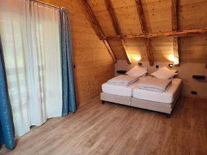 a bedroom with two beds in a wooden cabin at Chalet Le Petit Plus in Vaujany