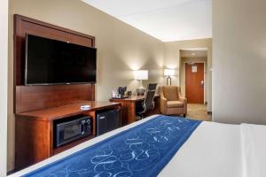 a hotel room with a bed and a flat screen tv at Comfort Suites Manchester near Arnold AFB in Manchester
