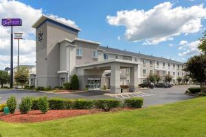a large building with a parking lot in front of it at Sleep Inn & Suites Smyrna - Nashville in Smyrna