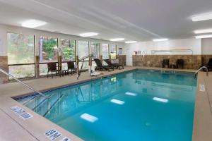 a swimming pool with blue water in a building at Comfort Inn & Suites in Canton