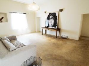 a living room with a couch and a picture on the wall at Mas Rauric in Llagostera