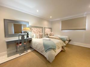 a bedroom with two beds and a mirror at Induku in Paternoster