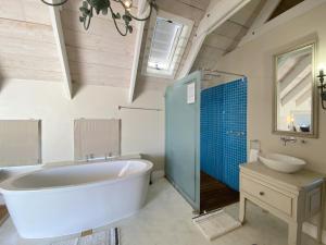 a bathroom with a tub and a sink and a toilet at Induku in Paternoster +17 photos