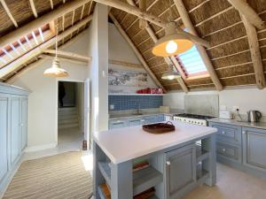 a kitchen with blue cabinets and a white island at Induku in Paternoster