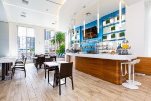 a restaurant with a bar and tables and chairs at Modern Studio rental at Beachwalk Resort Hollywood 18th floor in Hollywood