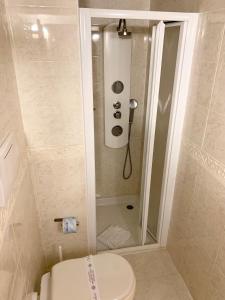 a small bathroom with a toilet and a shower at Hotel Regina Margherita in Rome