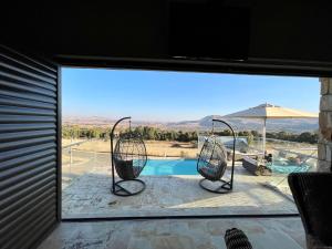 a view of a pool through a sliding glass door at Clarens Grand Villa in Clarens