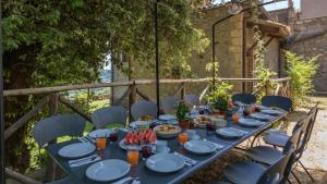 a blue table with plates and bowls of food on it at Villa Buon Viaggio 16, Emma Villas in Orvieto