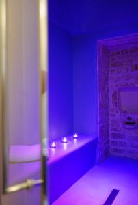 a purple room with a counter with lights on it at Borgo dei Lecci Puglia in Selva di Fasano