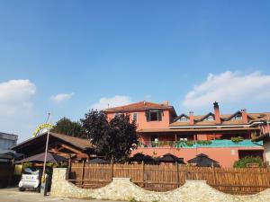 a building with a wooden fence in front of it at Hotel The Marins in Bra