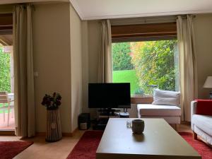Televízia a/alebo spoločenská miestnosť v ubytovaní Precioso adosado en Urbanización con campo de golf