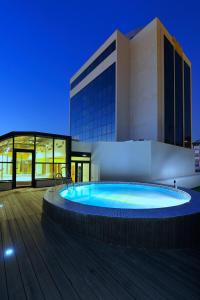 a large swimming pool in front of a building at Hotel Tent Granada in Granada