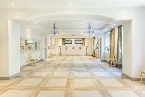 an empty hallway with a large room with white walls and wooden floors at Villa Buon Viaggio 16, Emma Villas in Orvieto +73 photos