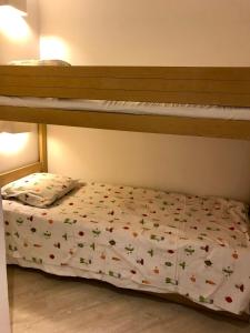 a bedroom with a bunk bed with a bedspread with butterflies at STEPS TO THE BEACH apart in CANNES with Parking in Cannes