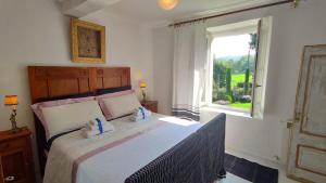 a bedroom with a large bed with a window at Natura e Arte in Pavullo nel Frignano
