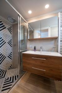 a bathroom with a sink and a shower at Villa Vesta Retiré - Kalamata Mediterranean Villas in Kalamata