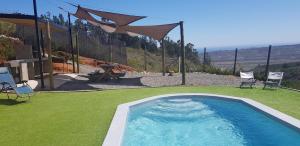 una piscina en un patio con sillas y mesa en Tunquen Campomar Quincho y Piscina, en Algarrobo