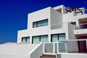 a white building with a staircase in front of it at CasaMandy CotilloMar in Cotillo