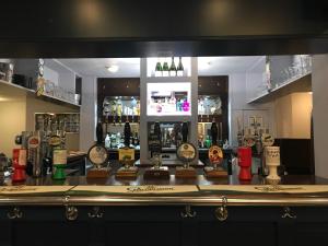 a bar with a bunch of clocks on the counter at The Halfway House Inn in Leeds