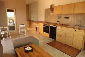 A kitchen or kitchenette at Horizonte Seafront Suites
