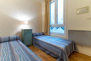 Ένα ή περισσότερα κρεβάτια σε δωμάτιο στο Hôtel Capfun Le Saint Germain, Paris