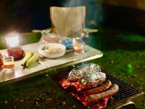 a grill with sausage and other food on a table at Mount Fuji Castle 2 in Yamanakako