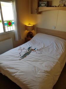 a white bed with a peacock painted on it at Private caravan situated at Parkdean Holiday Resort St Margaret's at Cliffe number 18 in St Margarets at Cliff