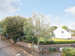 a house with a stone wall and a yard at Park House in Torquay