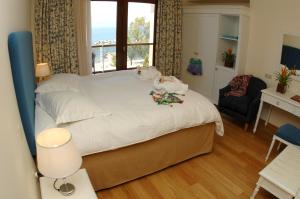 a bedroom with a large bed with a window at Valis Resort Hotel in Volos