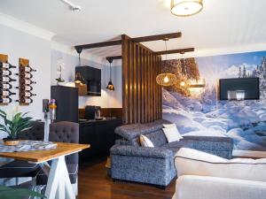 a living room with a couch and a table at ALPENLIEBE Design Hotel in Inzell