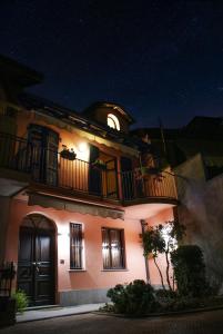 a lit up building with a balcony at night at Casa Caroli - intera casa ad Alba, LANGHE UNESCO in Alba