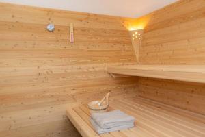 a wooden sauna with a stack of towels in it at Ferienhaus Schilcherland in Hochneuberg