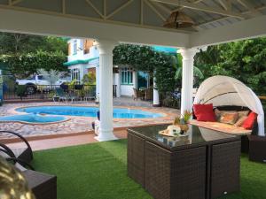 a backyard with a swimming pool and a gazebo at Panorama Villa in La Gaulette