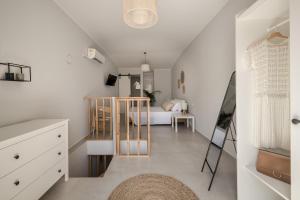 a bedroom with a bed and a room with white walls at Cabanelli in Zakynthos