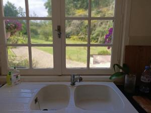 a kitchen sink in front of a window at Mas des Maje in Boisredon