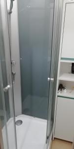 a shower with a glass door in a bathroom at Pavillon Greve in Greve