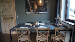 a dining room table with four chairs around it at Ferienwohnung Gipfelglück zwischen Bikepark & Skipiste in Winterberg