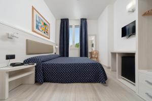Ένα ή περισσότερα κρεβάτια σε δωμάτιο στο Hotel Giotto