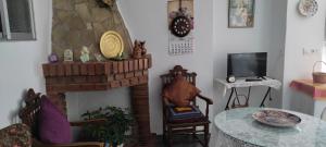 a living room with a table and a fireplace at Casa Lola in Montefrío