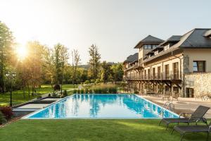 a swimming pool in a yard next to a building at Resort Sobotín in Sobotín
