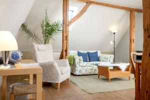 a living room with a couch and chairs at Gutshaus Ketelshagen in Putbus