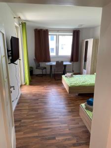 a room with two beds and a table in it at Onkel Tom Amazonien & Ozeanien in Paderborn