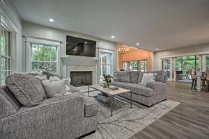 a living room with two couches and a fireplace at Luxury Family Home with Deck, Swim Spa and Grill! in New Buffalo