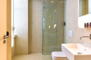 a bathroom with a glass shower and a sink at My Story Hotel Augusta in Lisbon